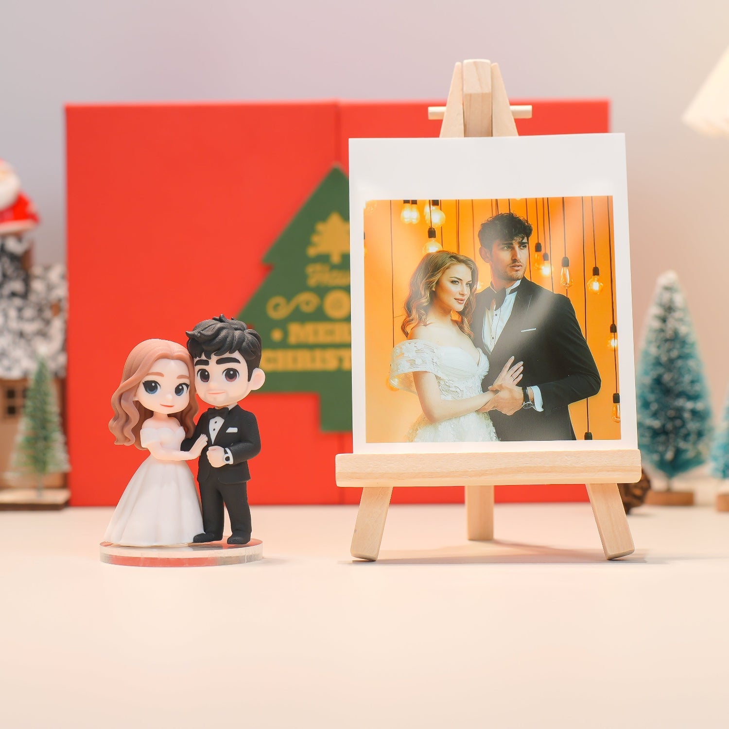 Wedding cake toppers with a couple and a photo of a couple in front of a Christmas tree.