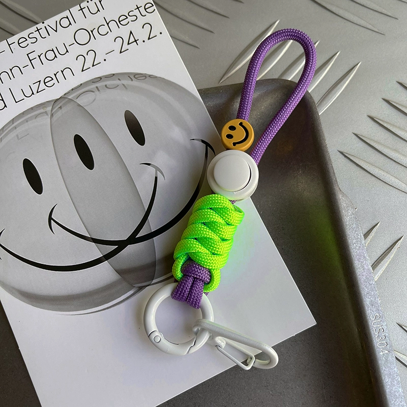 Keychain with smiley face design on a white surface