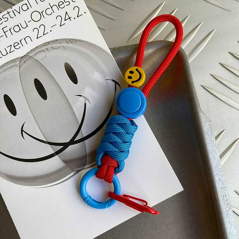 Colorful keychain with smiley face design on a white surface