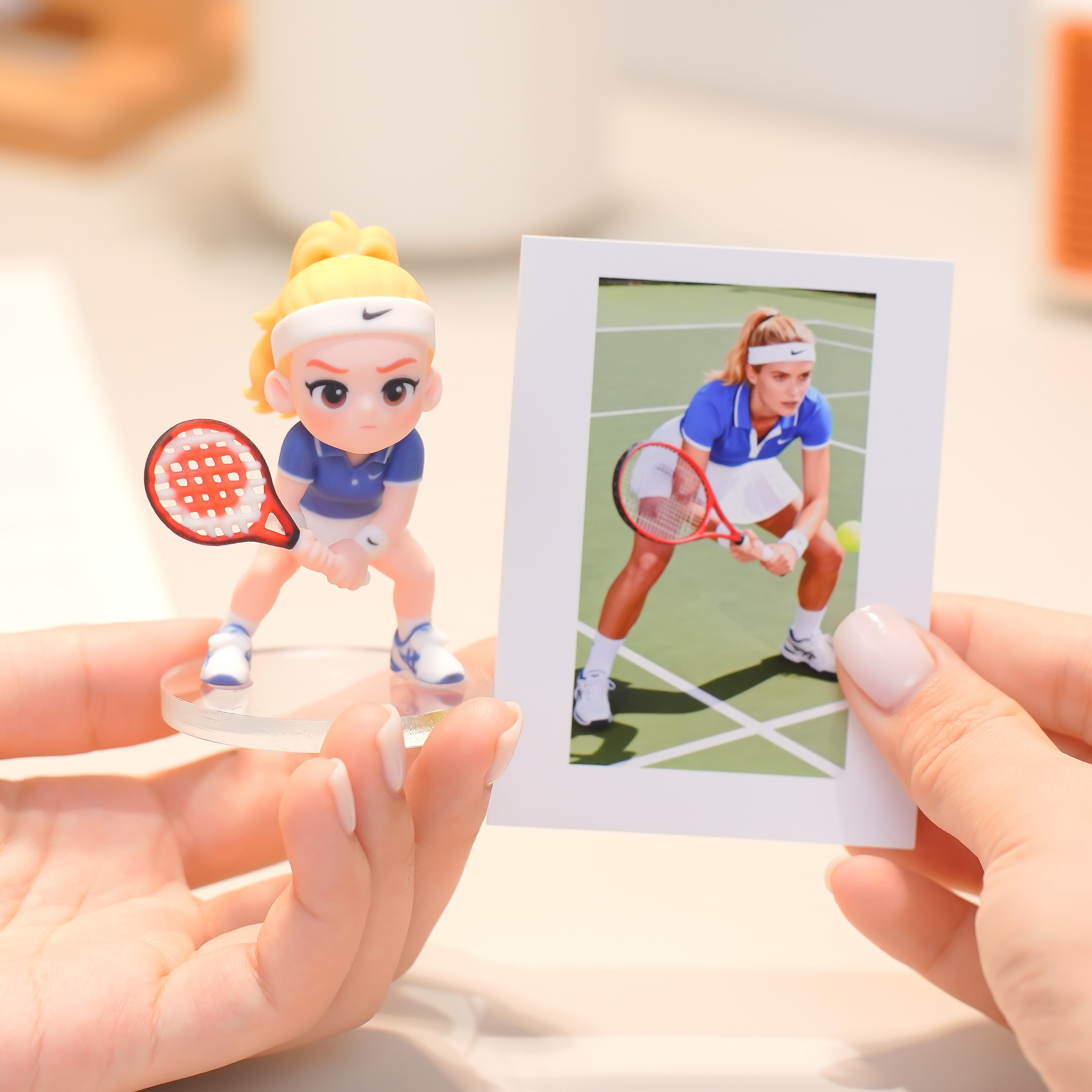 Bobblehead figure of a person taking a selfie with a photo of the same person on a stand.