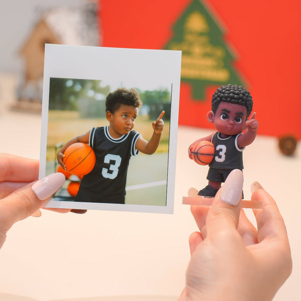 Person holding a photo of a child playing basketball next to a corresponding action figure.