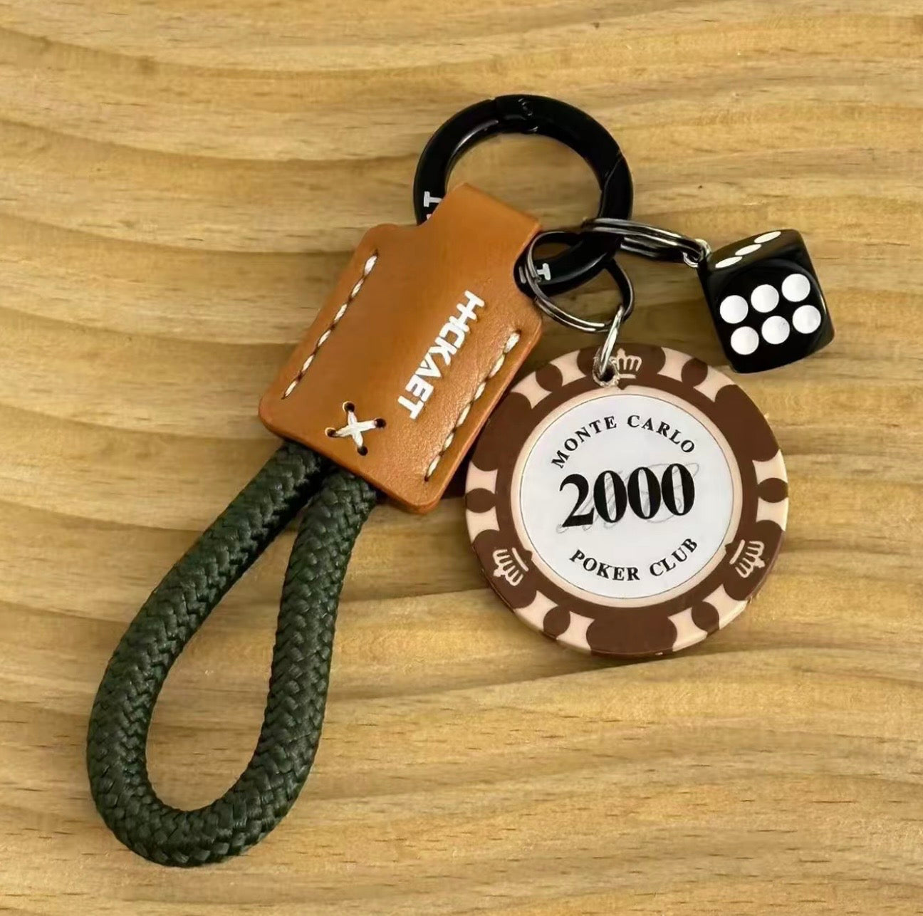 Keychain with poker chip and dice design on a wooden surface