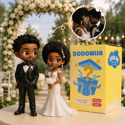 custom chibi couple figurine placed securely on top of a white tiered wedding cake as a personalized cake topper